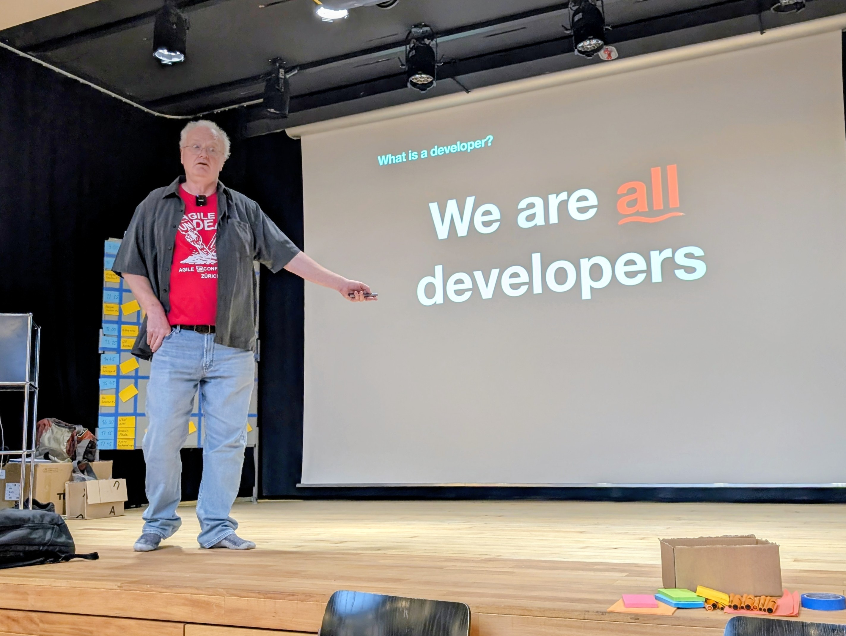 Dave Thomas on stage with a slide saying, We are all developers